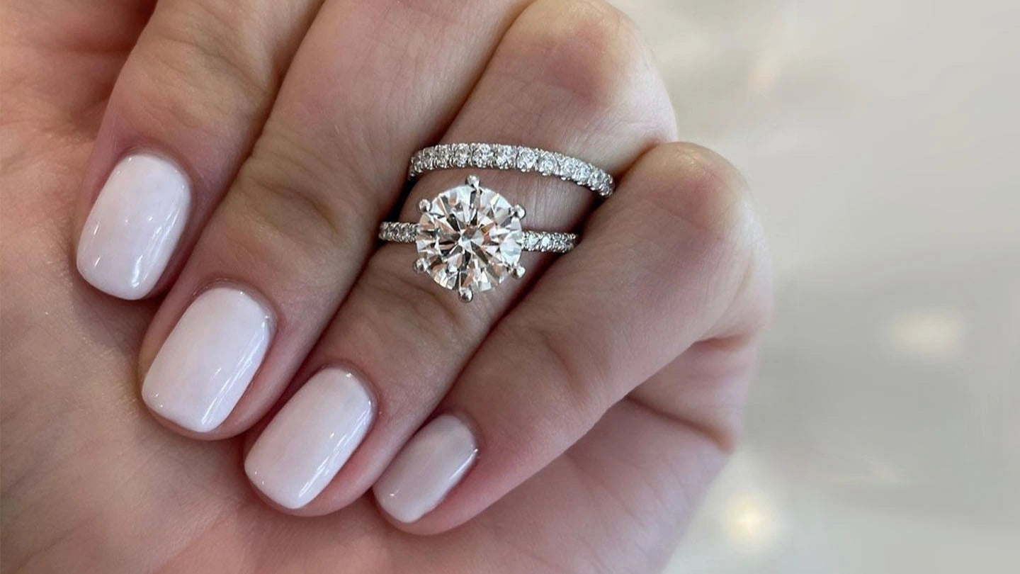 Diamond ring and wedding band worn together on a hand